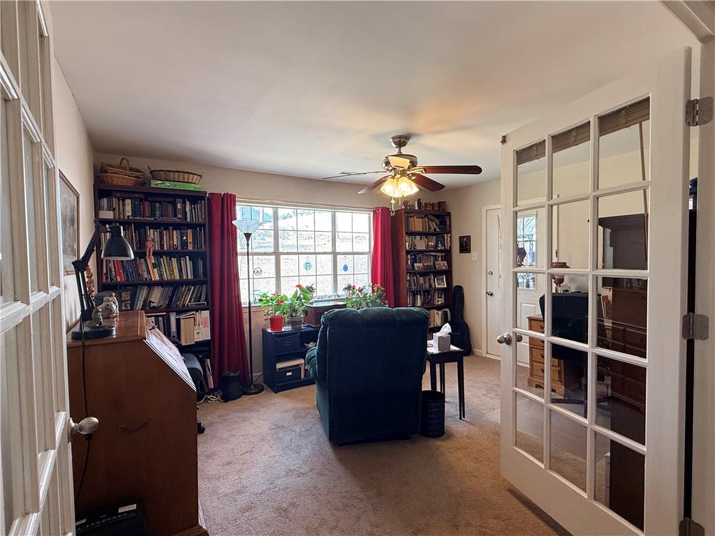 3680 Hamilton Dam Road Dacula, GA 30019 - Photo 17 of 33 a living room with furniture a bookshelf and a window