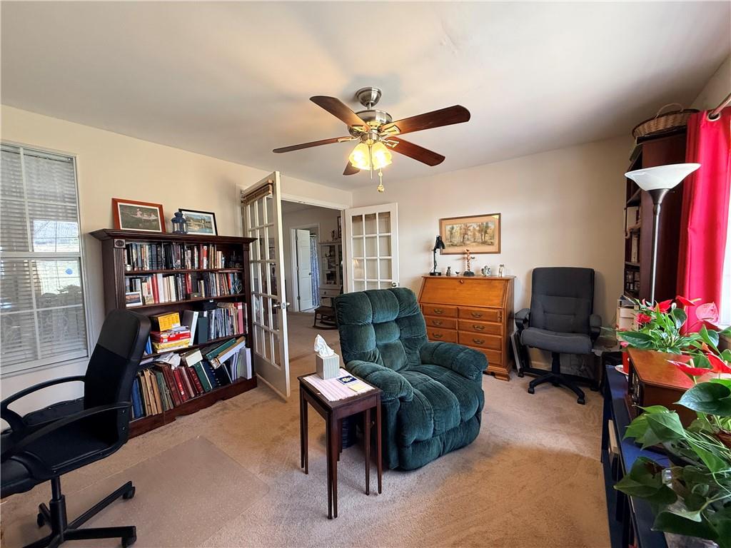 3680 Hamilton Dam Road Dacula, GA 30019 - Photo 18 of 33 a living room with furniture a bookshelf and a window
