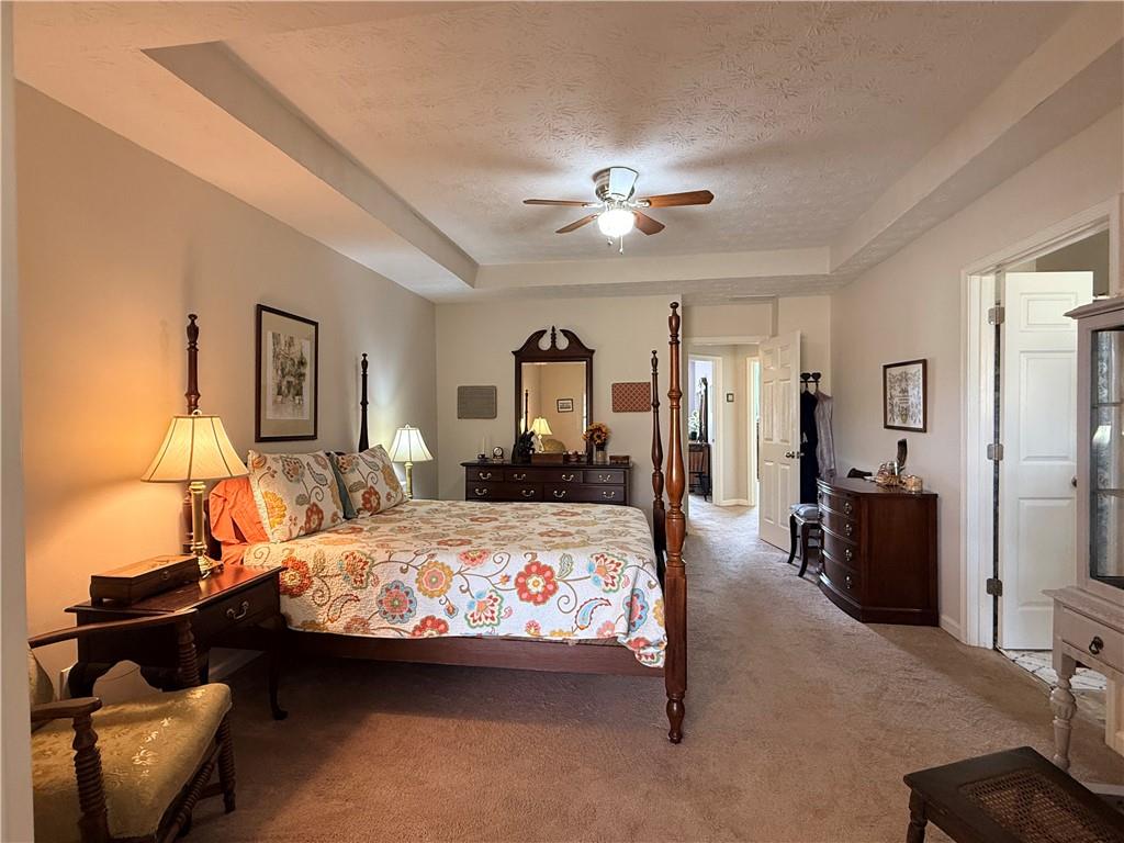 3680 Hamilton Dam Road Dacula, GA 30019 - Photo 19 of 33 a bedroom with a bed a couch and dresser