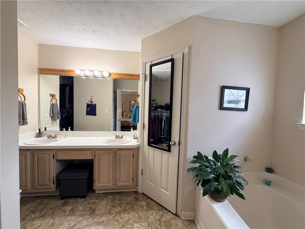 3680 Hamilton Dam Road Dacula, GA 30019 - Photo 20 of 33 a spacious bathroom with a sink and a mirror