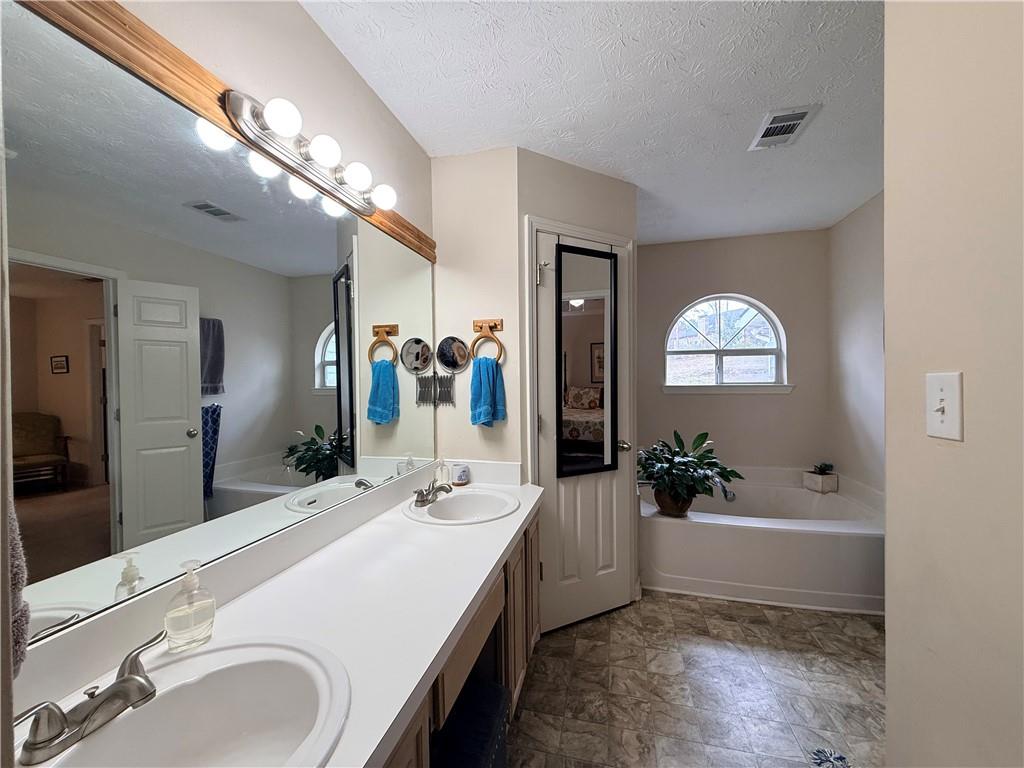 3680 Hamilton Dam Road Dacula, GA 30019 - Photo 22 of 33 a spacious bathroom with a sink and a mirror