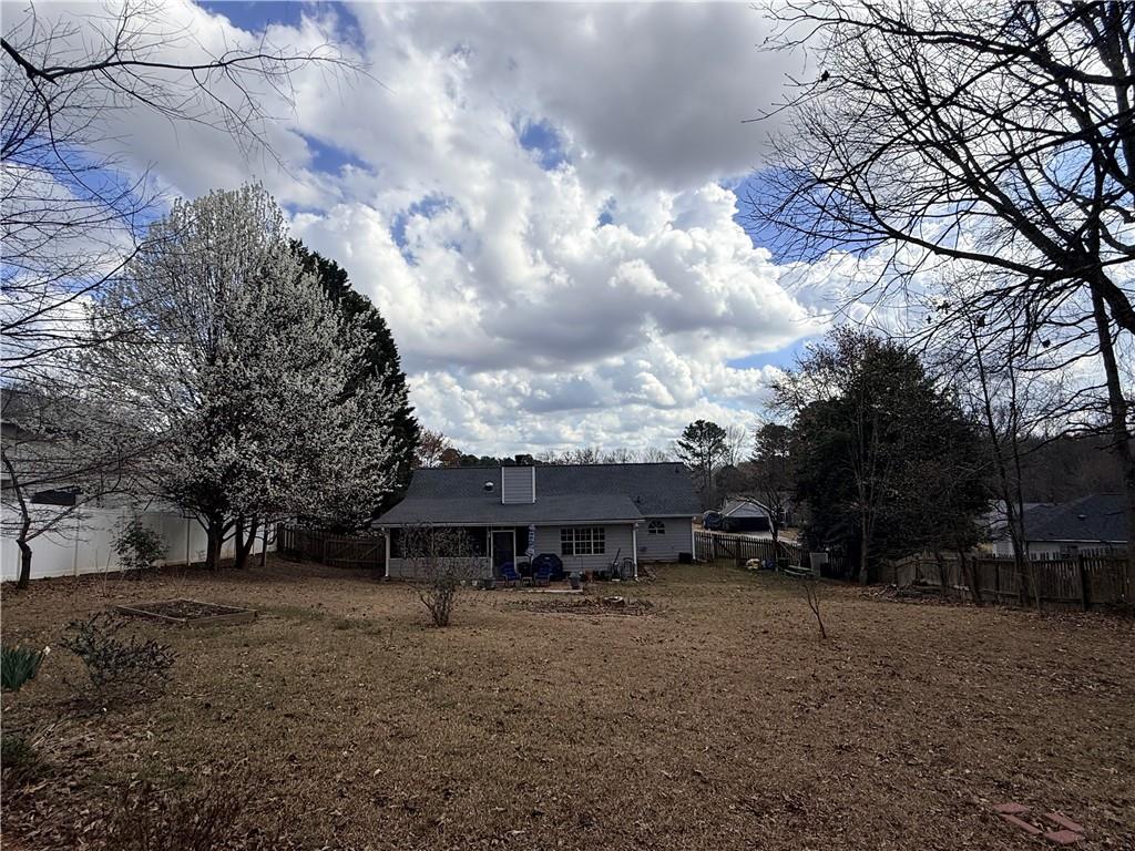 3680 Hamilton Dam Road Dacula, GA 30019 - Photo 33 of 33 a view of a house with a yard and wooden fence