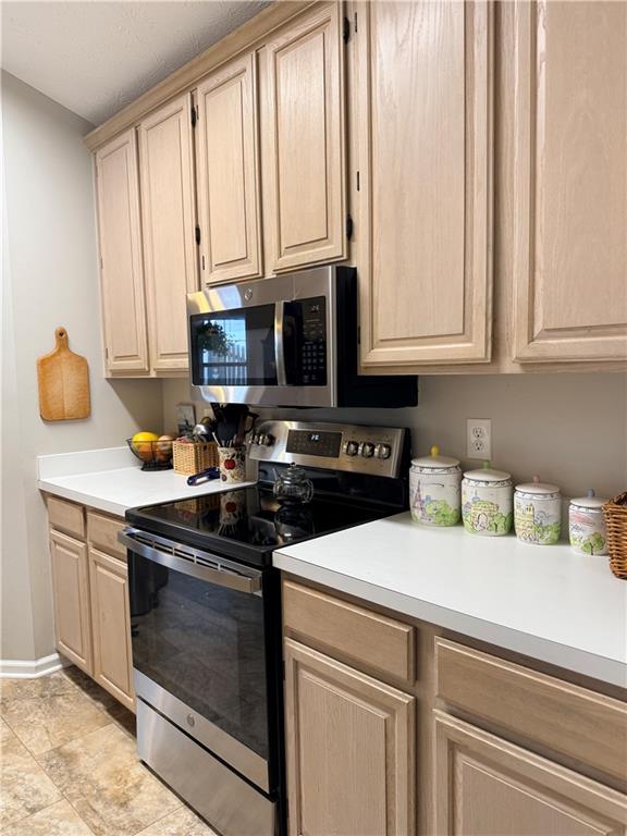 3680 Hamilton Dam Road Dacula, GA 30019 - Photo 4 of 33 a kitchen with stainless steel appliances granite countertop white cabinets and a stove top oven