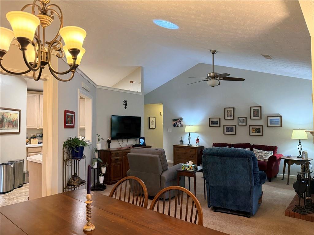 3680 Hamilton Dam Road Dacula, GA 30019 - Photo 10 of 33 a living room with furniture a chandelier and a flat screen tv