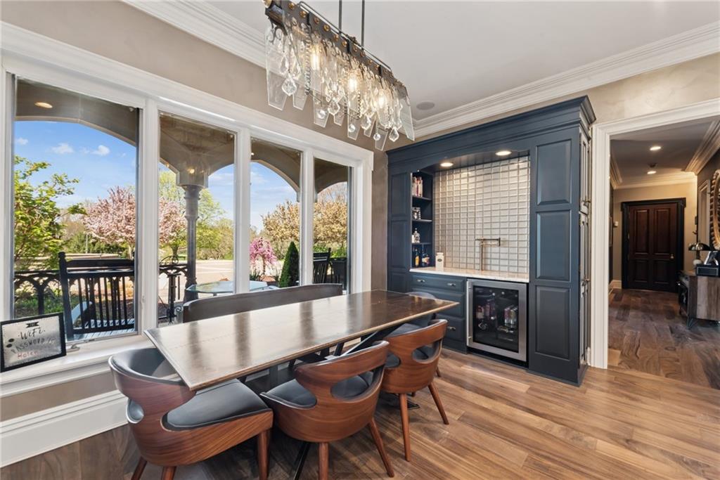 152 Justabout Road Venetia, PA 15367 - Photo 17 of 50 a dining room with wooden floor a chandelier a wooden table and chairs