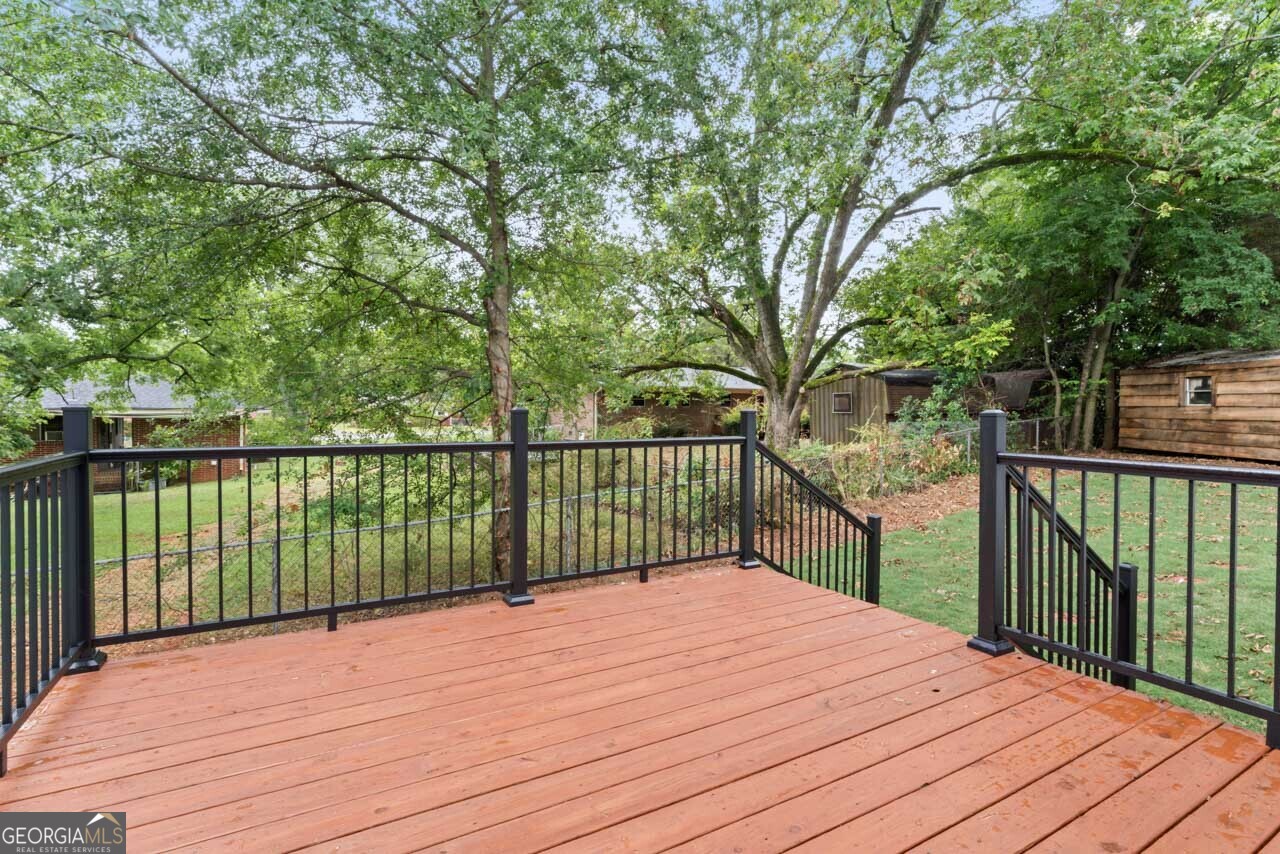 9 Lemon Street McDonough, GA 30253 - Photo 12 of 42 a balcony with wooden floor and fence