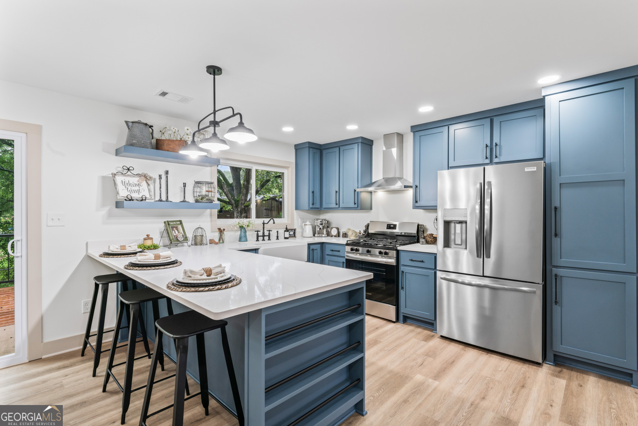 9 Lemon Street McDonough, GA 30253 - Photo 19 of 42 a kitchen with a refrigerator a stove a sink dishwasher with a dining table and chairs