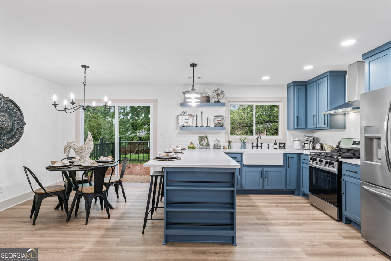 9 Lemon Street McDonough, GA 30253 - Photo 23 of 42 a kitchen with kitchen island granite countertop a stove and a wooden floors