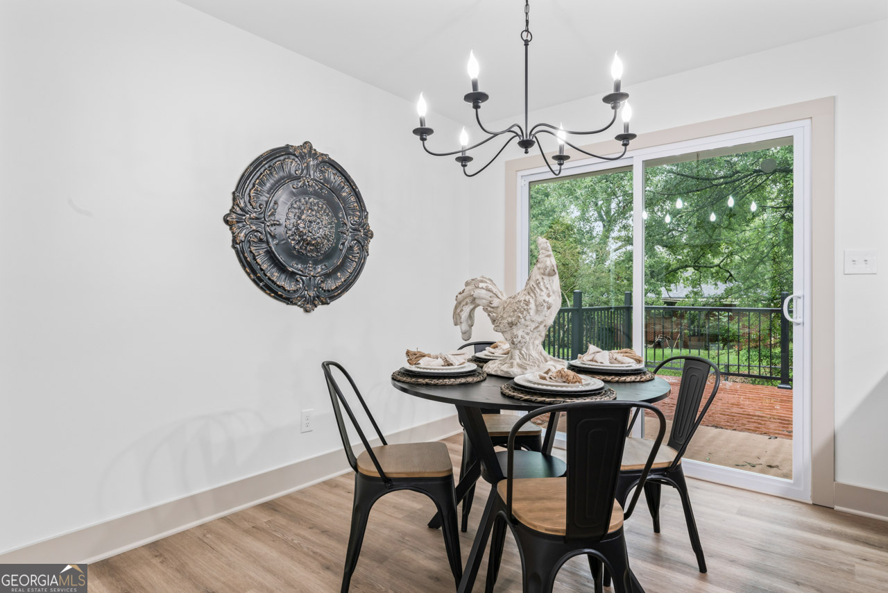 9 Lemon Street McDonough, GA 30253 - Photo 24 of 42 a view of a dining room with furniture wooden floor and chandelier