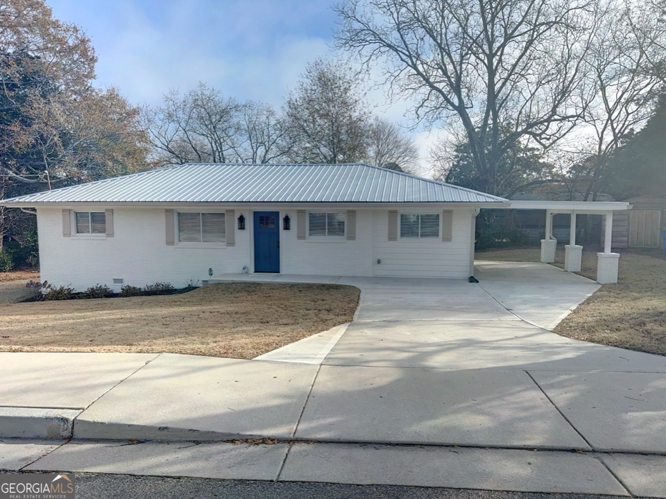 9 Lemon Street McDonough, GA 30253 - Photo 3 of 42 a view of a white house with a large tree next to a road