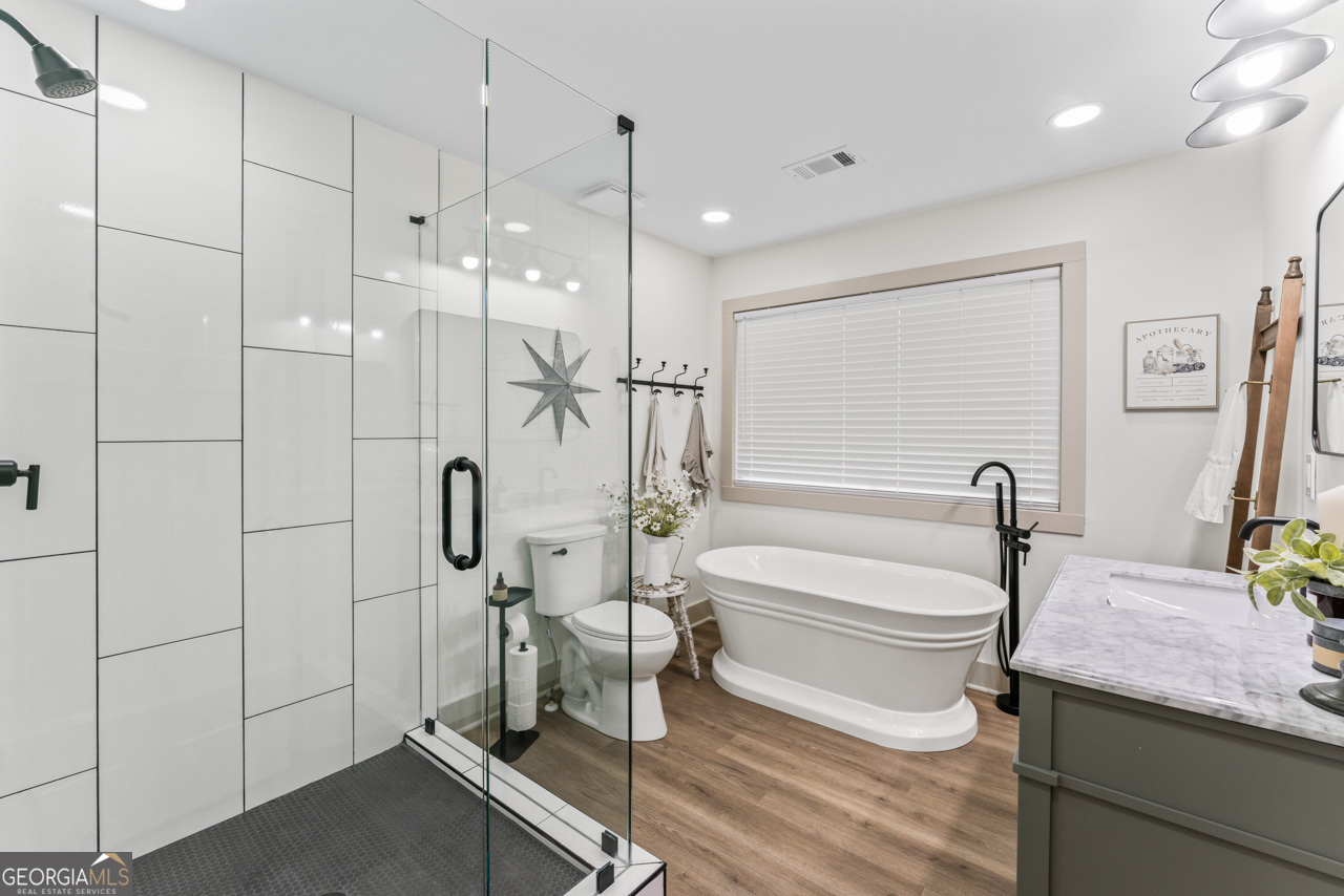 9 Lemon Street McDonough, GA 30253 - Photo 31 of 42 a bathroom with a sink a toilet and a shower