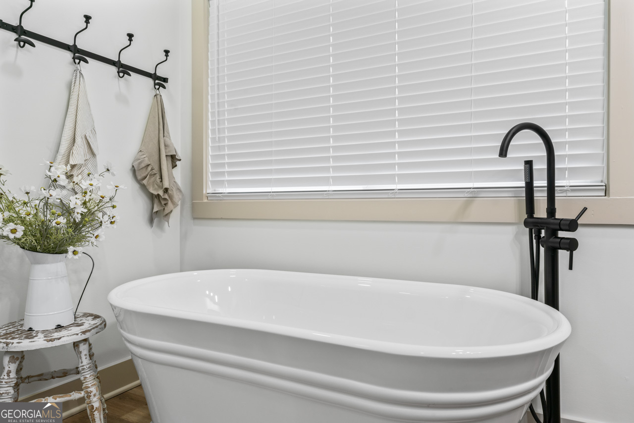 9 Lemon Street McDonough, GA 30253 - Photo 33 of 42 a bathroom with a white bath tub and a shower