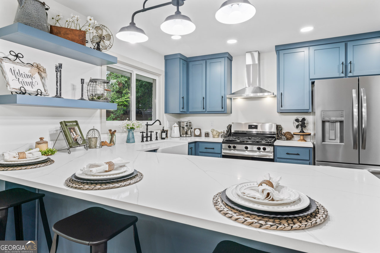 9 Lemon Street McDonough, GA 30253 - Photo 36 of 42 a kitchen with a table stainless steel appliances and cabinets
