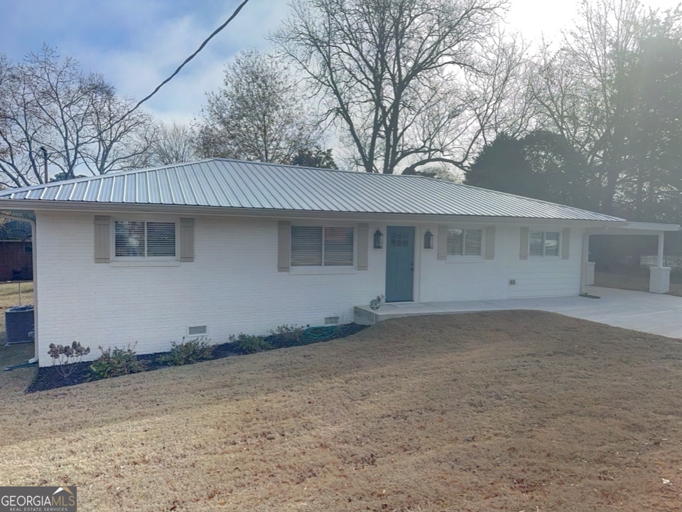 9 Lemon Street McDonough, GA 30253 - Photo 42 of 42 a front view of a house with a yard and garage