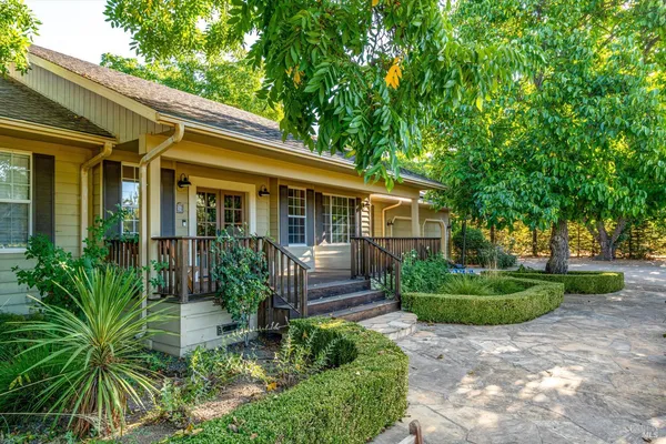 a front view of a house with a garden