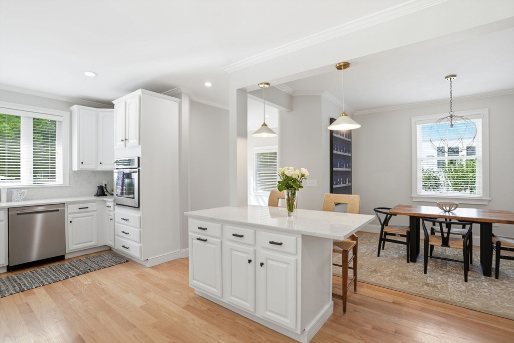 59 Elm Street Hingham, MA 02043 - Photo 9 of 33 a kitchen with a white cabinets and chairs
