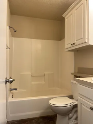 a bathroom with a sink a toilet and bathtub