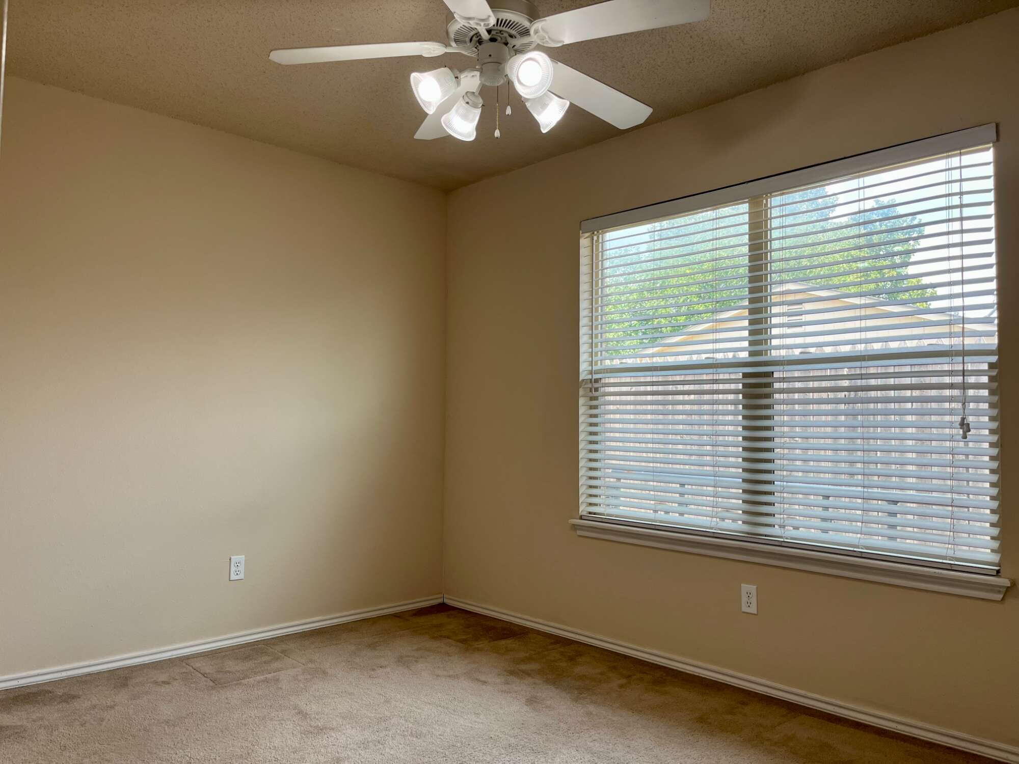 2401 73rd Street, Unit 16 Lubbock, TX 79423 - Photo 13 of 19 a view of an empty room with a window