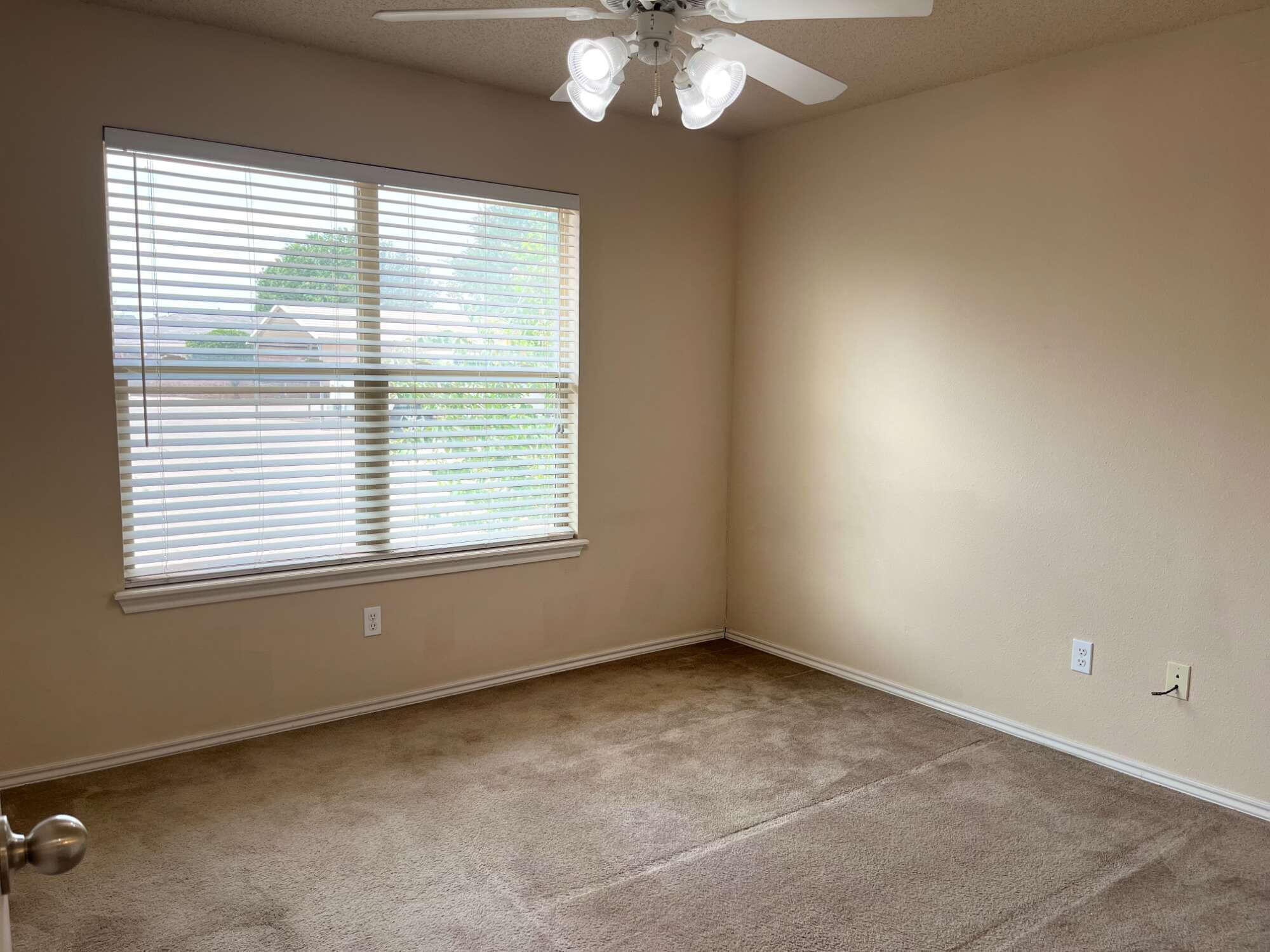 2401 73rd Street, Unit 16 Lubbock, TX 79423 - Photo 7 of 19 a view of an empty room with a window