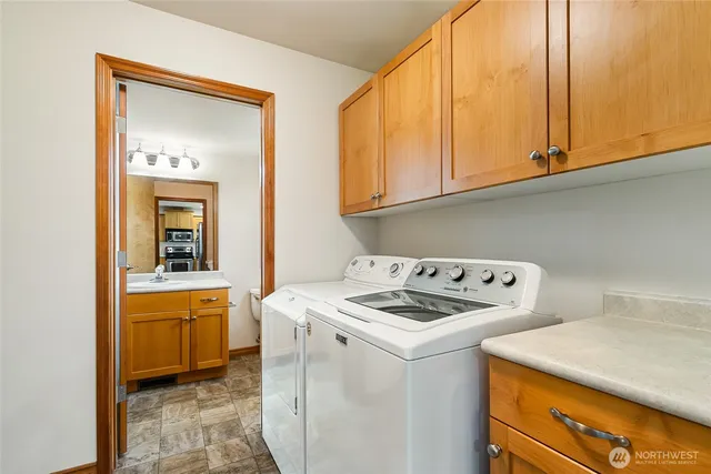 a bathroom with a granite countertop sink toilet and mirror