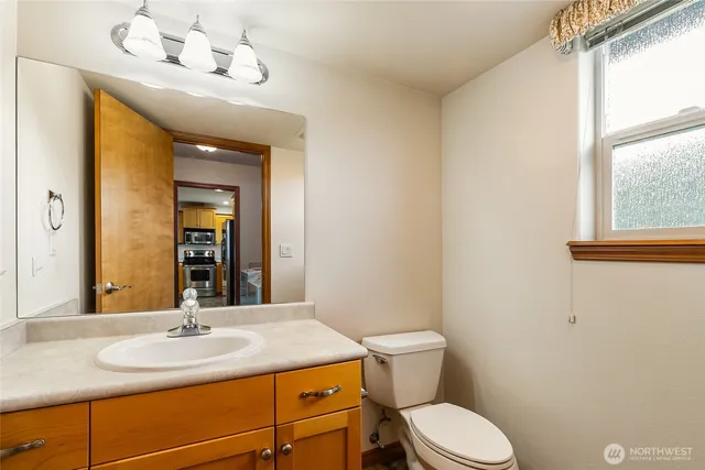 a view of a kitchen with wooden floor and electronic appliances