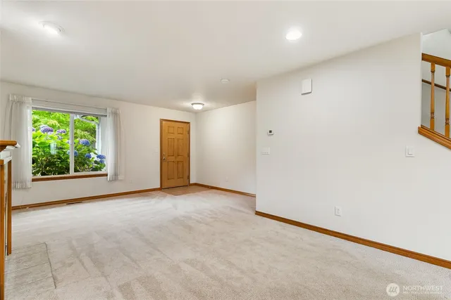 a view of a kitchen with kitchen island a large window a sink and a counter top space