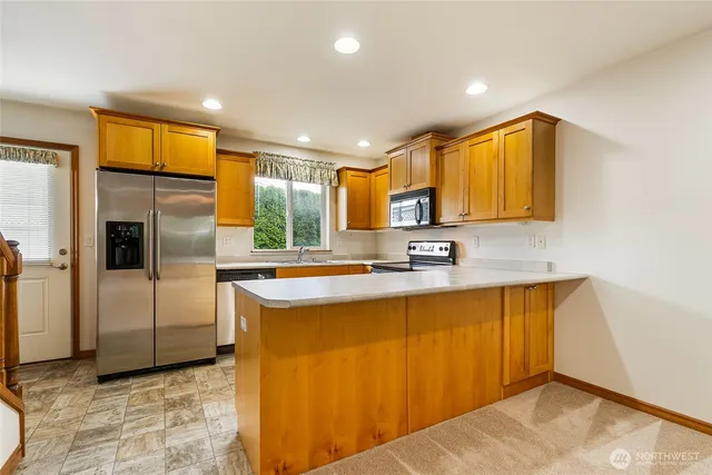 a kitchen with a stove a sink and a microwave