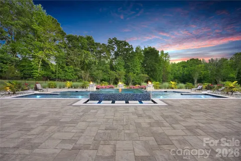 a view of yard with swimming pool and green space