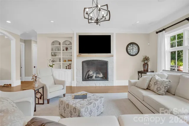 a spacious bedroom with a bed and a flat screen tv