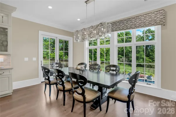 a dining room with furniture window and wooden floor
