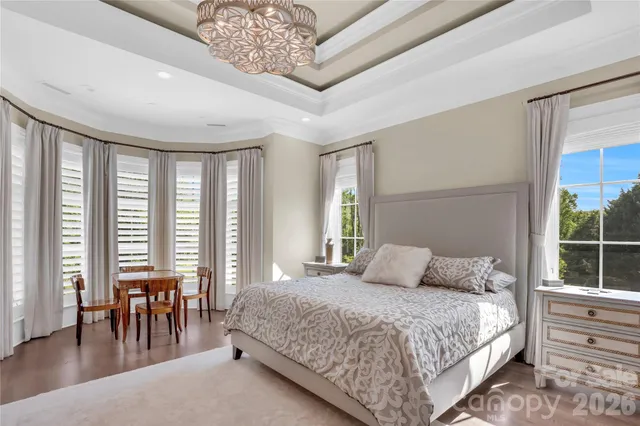 a living room with stainless steel appliances furniture a rug and a kitchen view