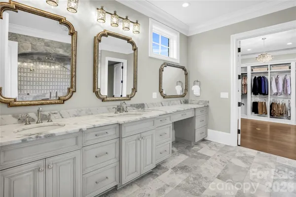 a bathroom with double vanity sinks a mirror and a shower