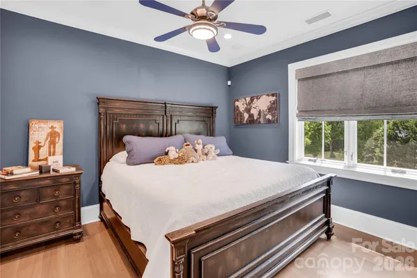 a bed sitting in a bedroom next to a window