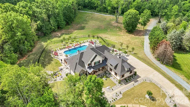 a view of yard with swimming pool and green space