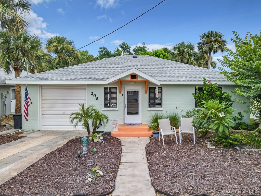 208 Crawford Road New Smyrna Beach, FL 32169 - Photo 1 of 26 a house view with a seating space and garden