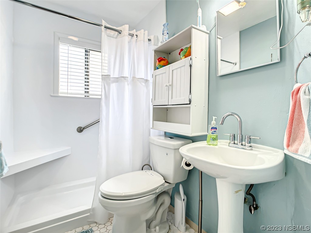 208 Crawford Road New Smyrna Beach, FL 32169 - Photo 13 of 26 a bathroom with a sink toilet and shower