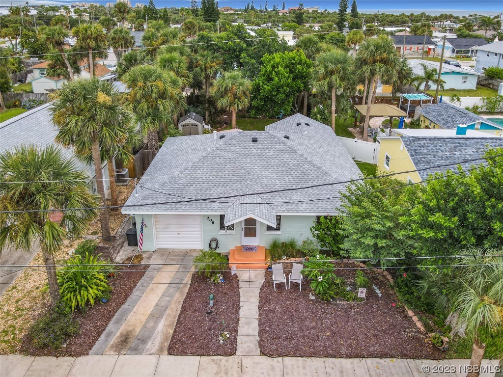 208 Crawford Road New Smyrna Beach, FL 32169 - Photo 2 of 26 an aerial view of a house with garden space and lake view