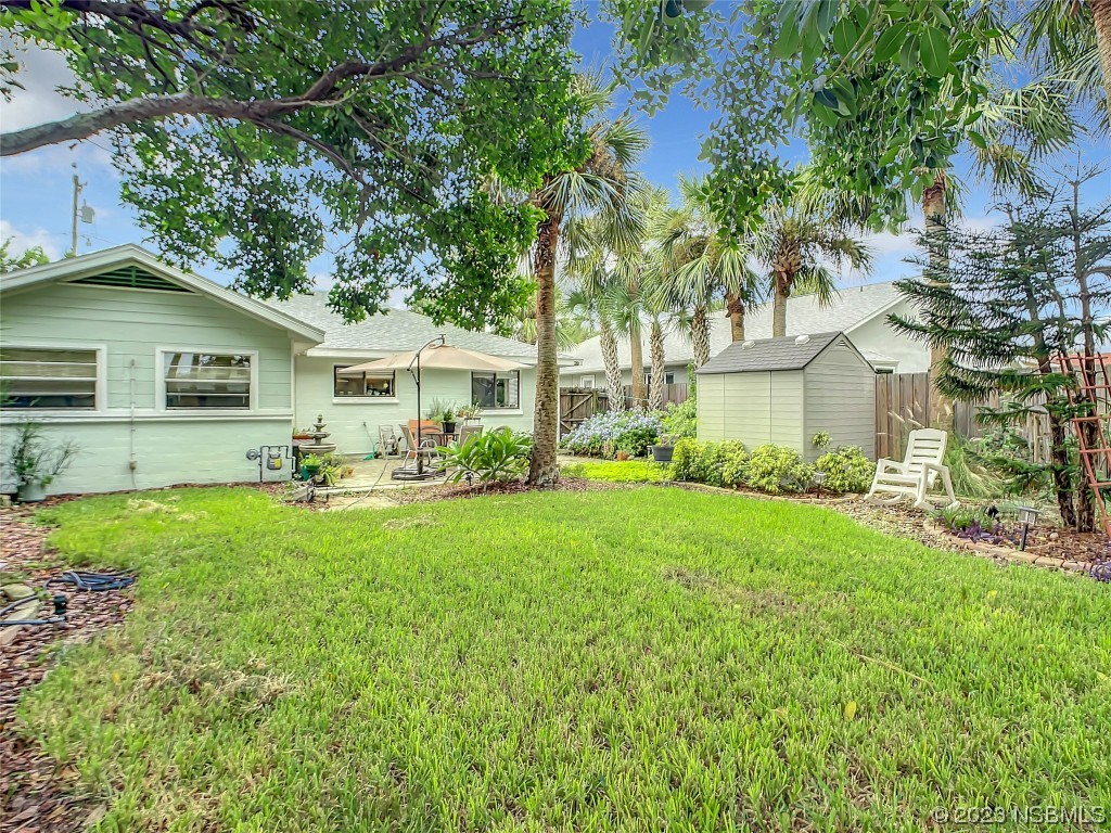 208 Crawford Road New Smyrna Beach, FL 32169 - Photo 4 of 26 a front view of a house with a yard and trees