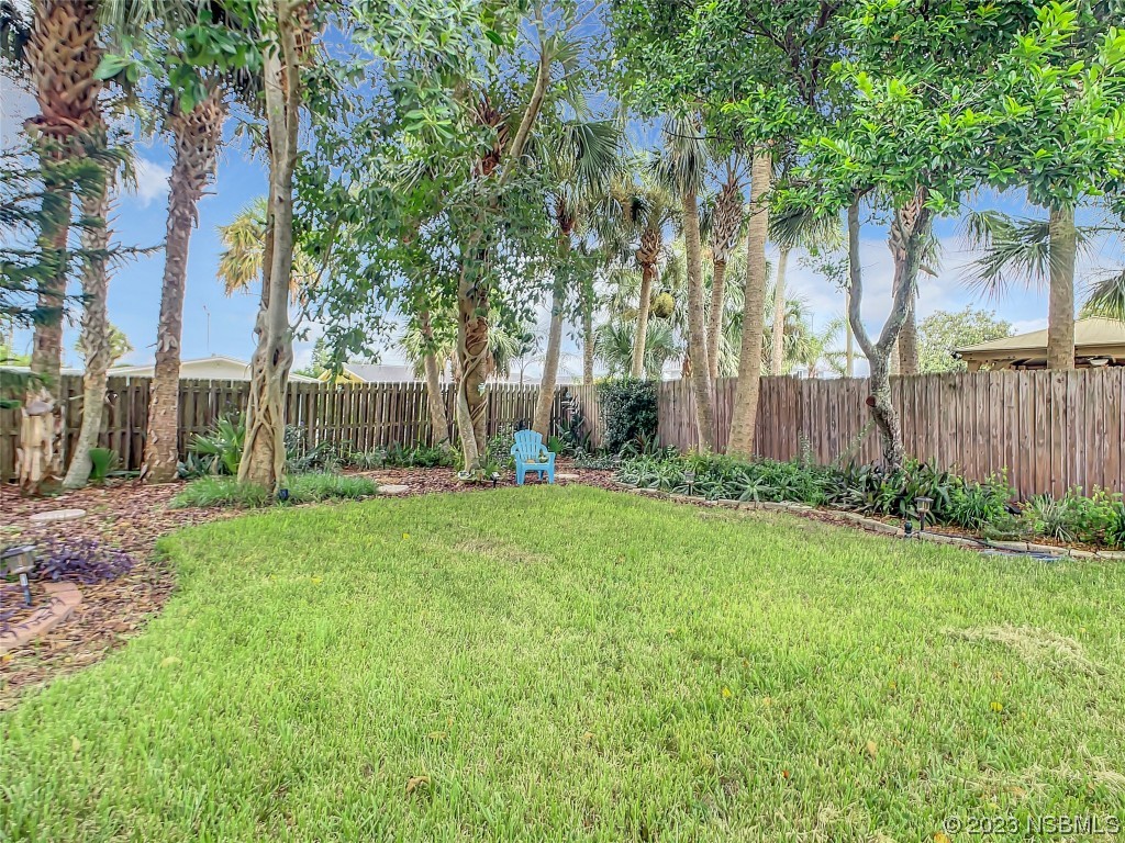 208 Crawford Road New Smyrna Beach, FL 32169 - Photo 6 of 26 a view of a backyard with large trees