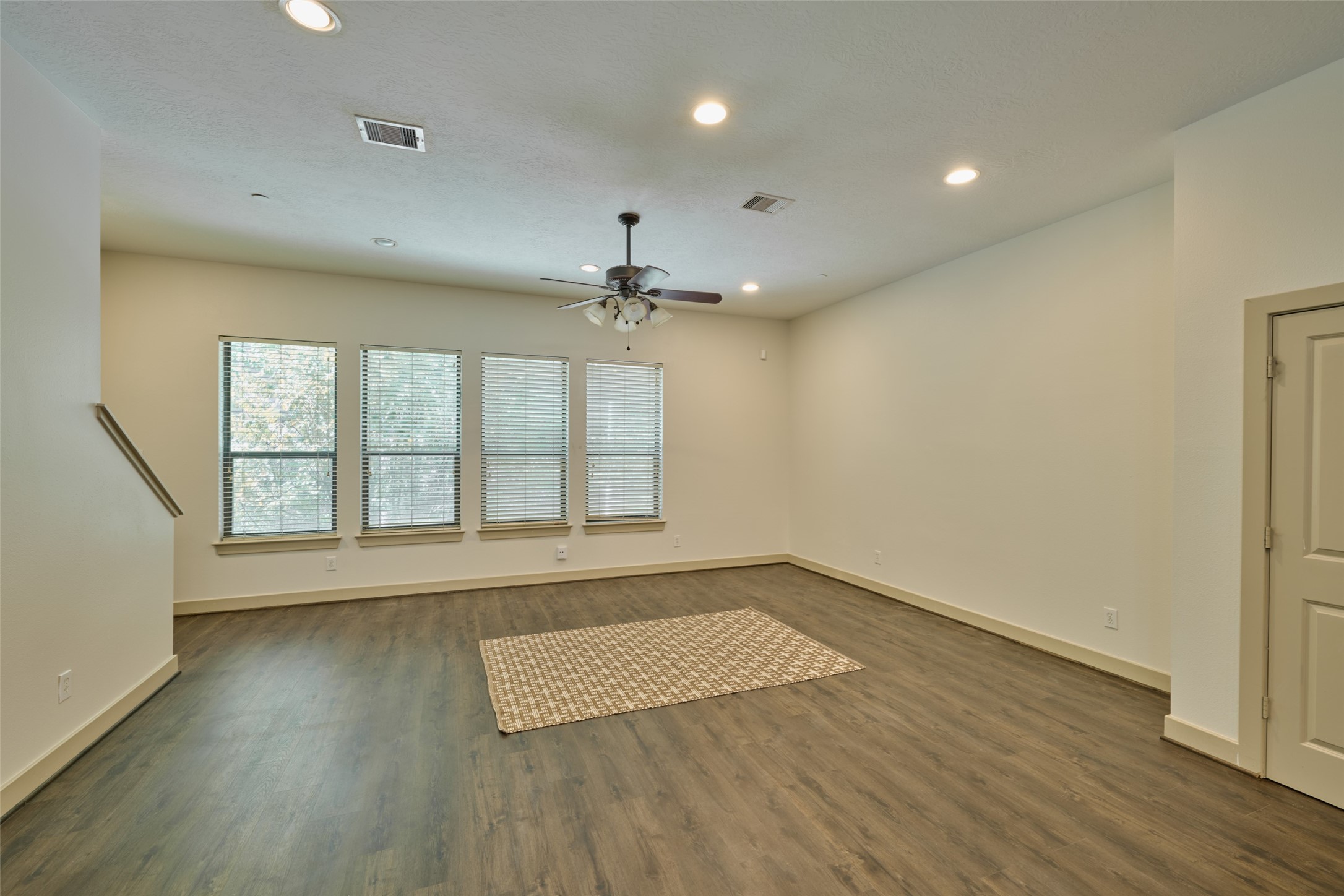 2422 Navigation Boulevard, Unit E Houston, TX 77003 - Photo 9 of 29 an empty room with wooden floor and windows