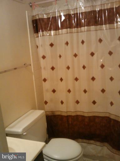 6473 Rockshire Court Alexandria, VA 22315 - Photo 5 of 12 a bathroom with a toilet and a shower