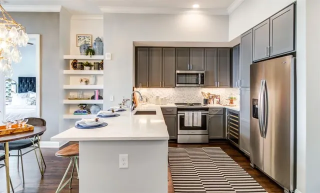 a kitchen with a sink stove and microwave