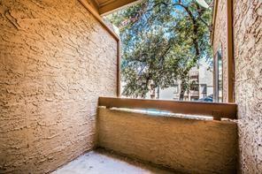 5550 Spring Valley Road, Unit E23 Dallas, TX 75254 - Photo 17 of 19 Patio area overlooking the pool area from living room.