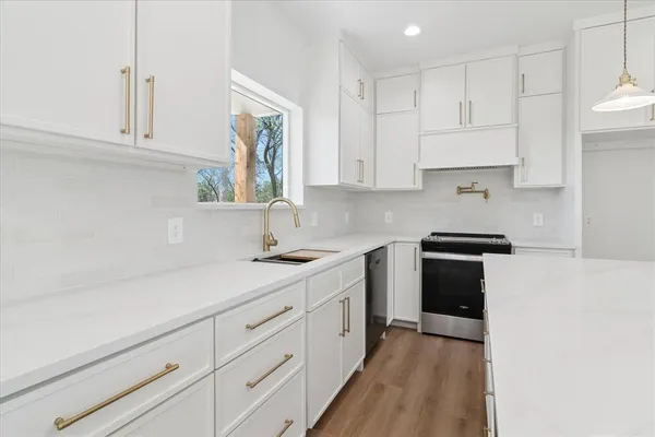a kitchen with white cabinets and white appliances