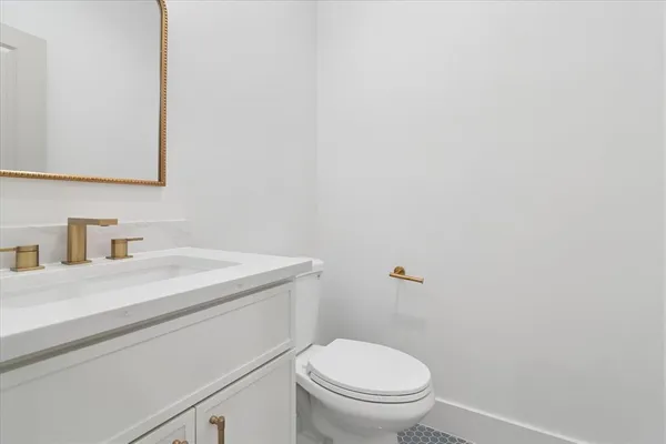 a bathroom with a sink a toilet and mirror