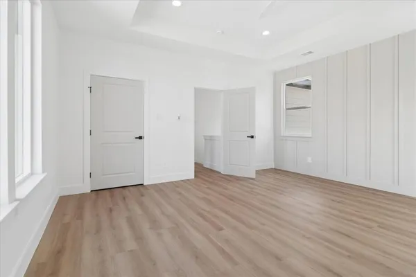 a view of an empty room with wooden floor