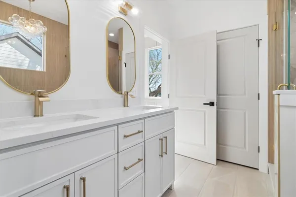 a bathroom with a double vanity sink and mirror