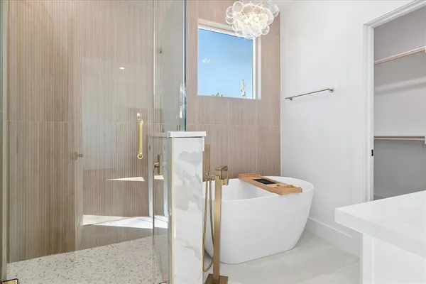 a bathroom with a bathtub and shower