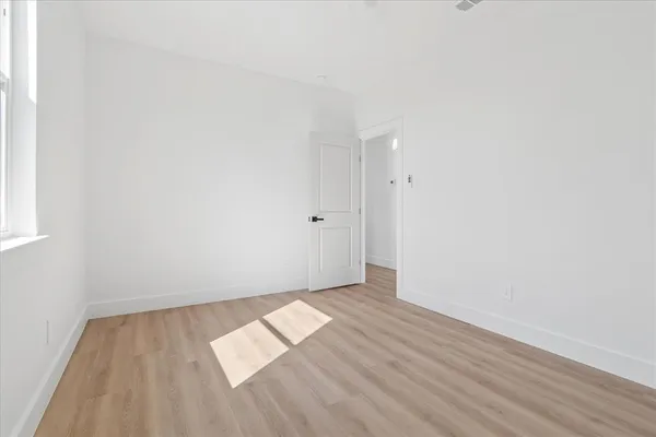 an empty room with wooden floor