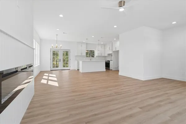 a view of a kitchen with kitchen island a counter top space a sink and cabinets